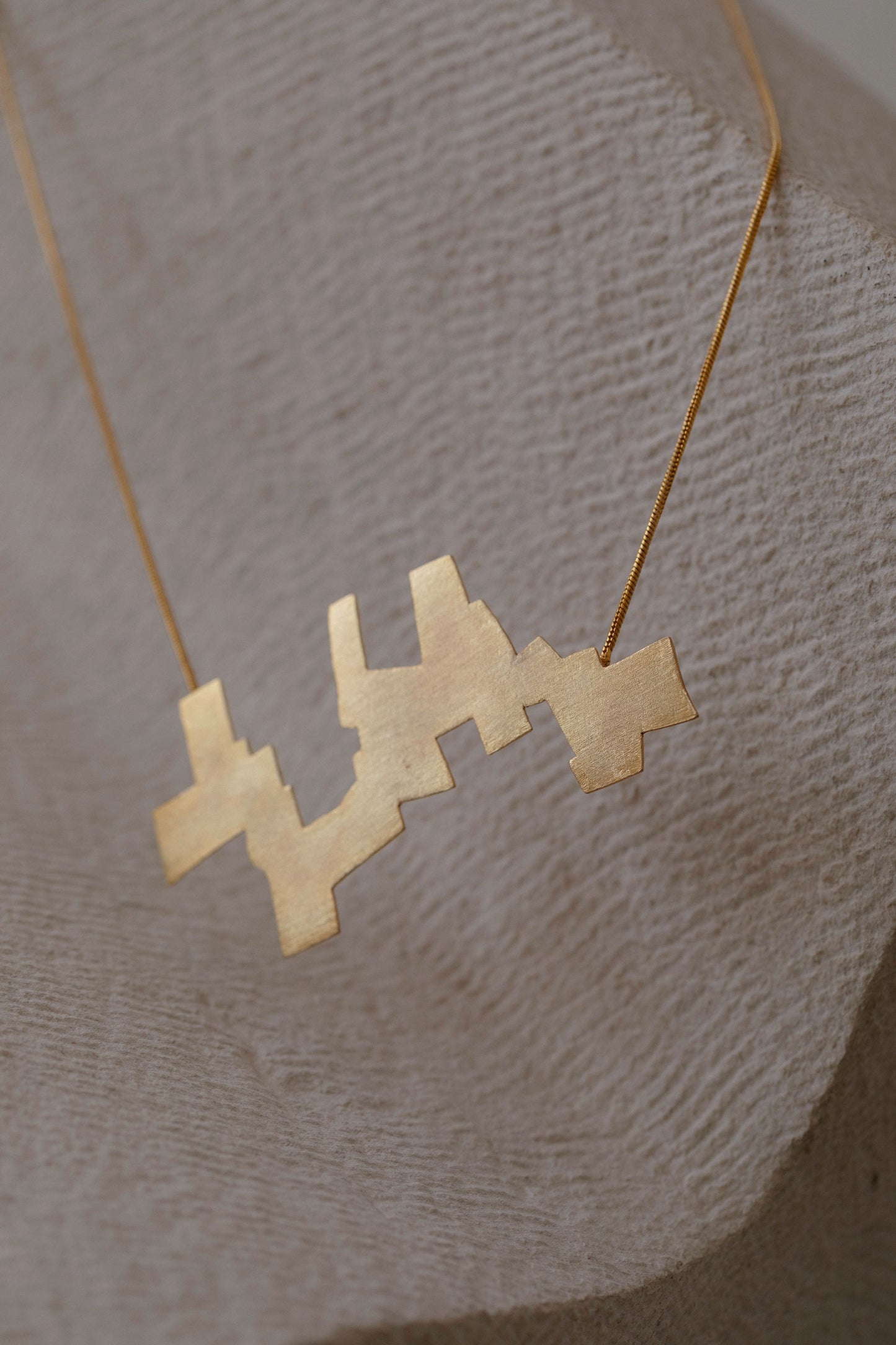 Ikur Brass Pendant Necklace
