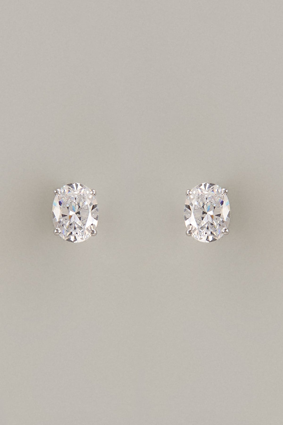 White Finish Oval Cut Swarovski Zirconia Stud Earrings In Sterling Silver