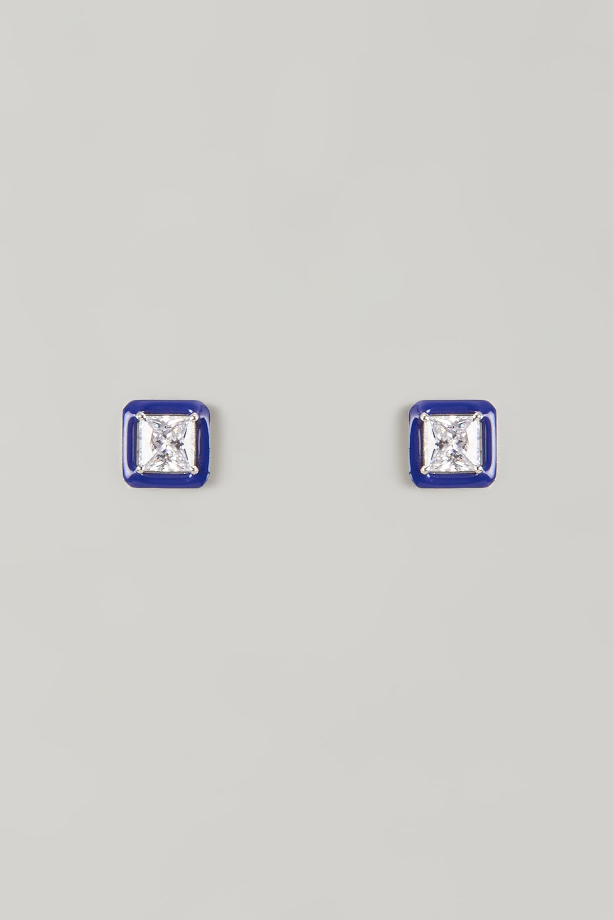 White Finish Blue Stone Stud Earrings In Sterling Silver