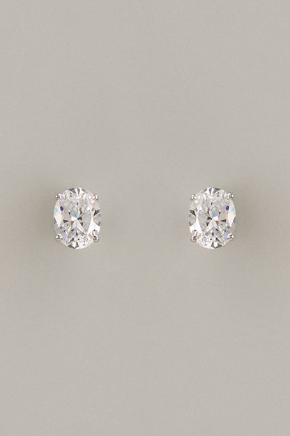 White Finish Oval Cut Swarovski Zirconia Stud Earrings In Sterling Silver