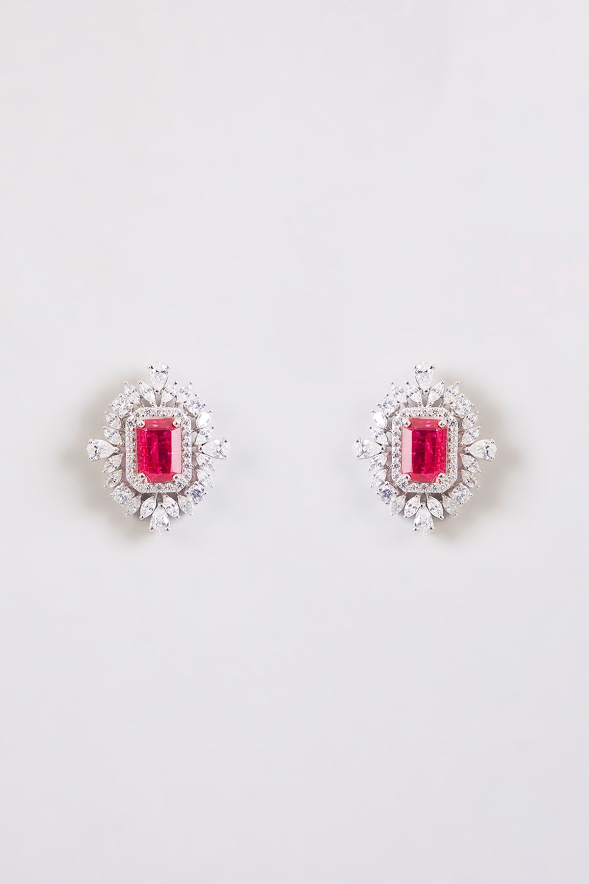 White Finish Zircon & Red Stone Stud Earrings In Sterling Silver