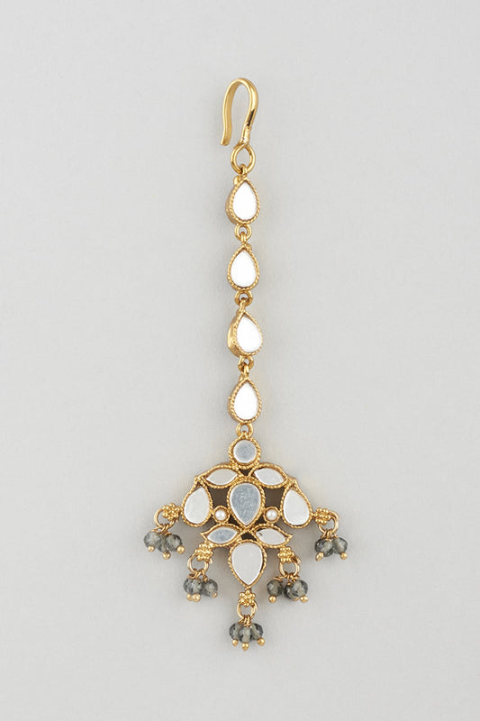 Gold Finish Light Grey Stone White Enamelled Jhumka Earrings With Mangtikka