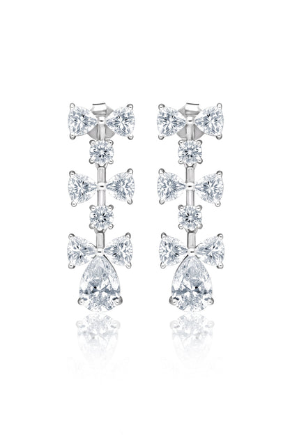 White Rhodium Finish Cubic Zirconia Luminous Bow Dangler Earrings In Sterling Silver