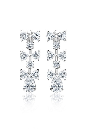 White Rhodium Finish Cubic Zirconia Luminous Bow Dangler Earrings In Sterling Silver