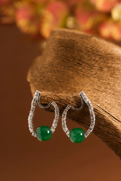 White Gold Finish Eurostar Zircons & Glass-Filled Emerald Stone Hoop Earrings In Sterling Silver