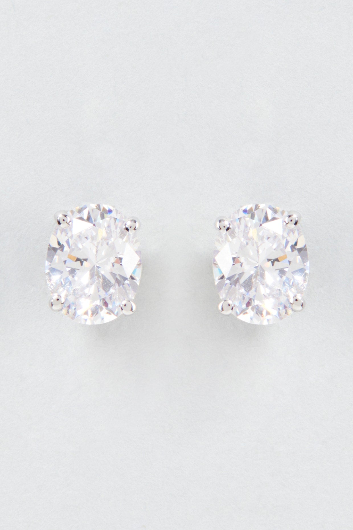 White Finish Oval Cut Swarovski Zirconia Stud Earrings In Sterling Silver