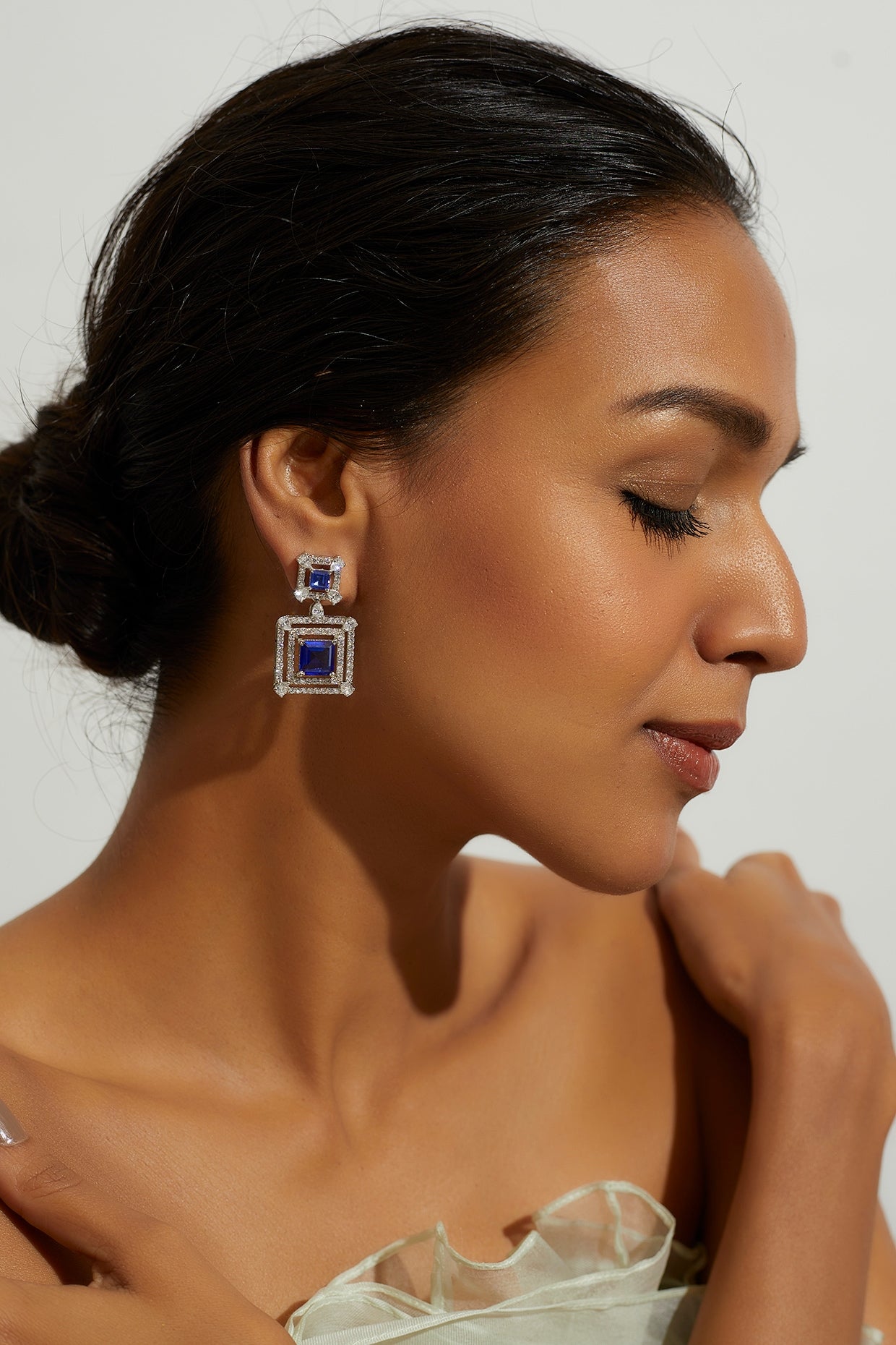 White Finish Zircon & Synthetic Blue Stone Dangler Earrings In Sterling Silver