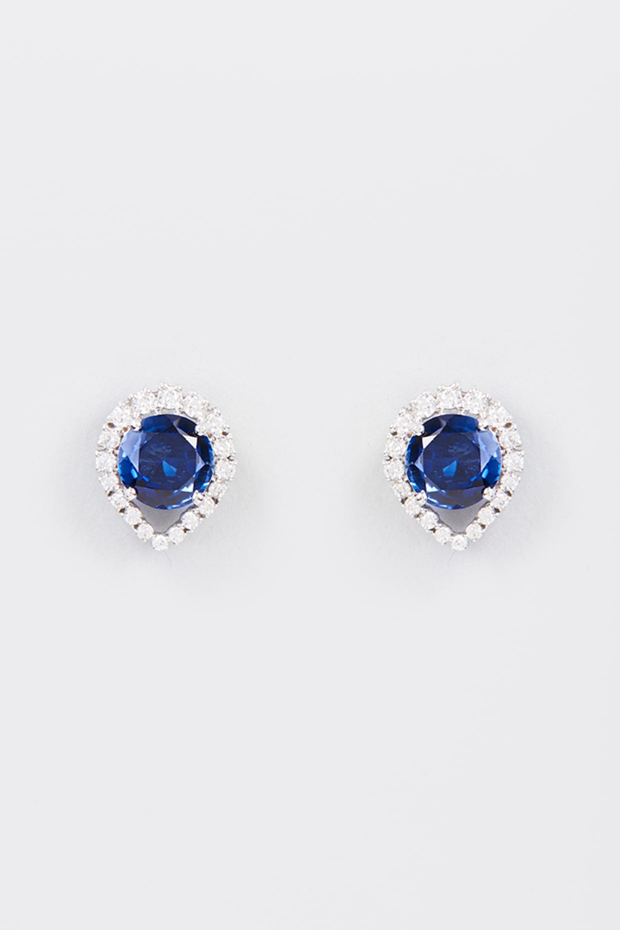 White Finish Zircon & Synthetic Blue Stone Stud Earrings In Sterling Silver