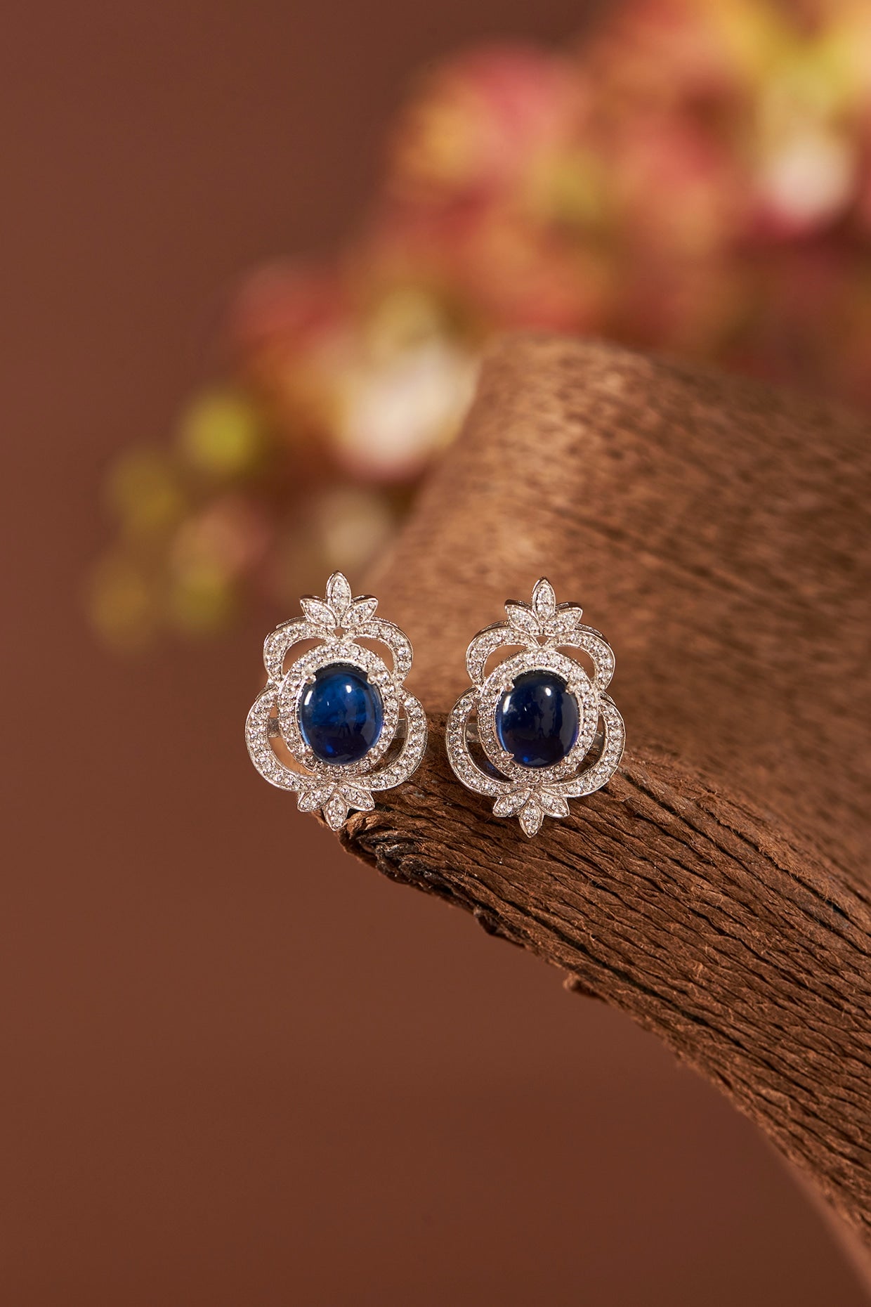 White Finish Eurostar Zirconia & Blue Sapphire Stud Earrings In Sterling Silver